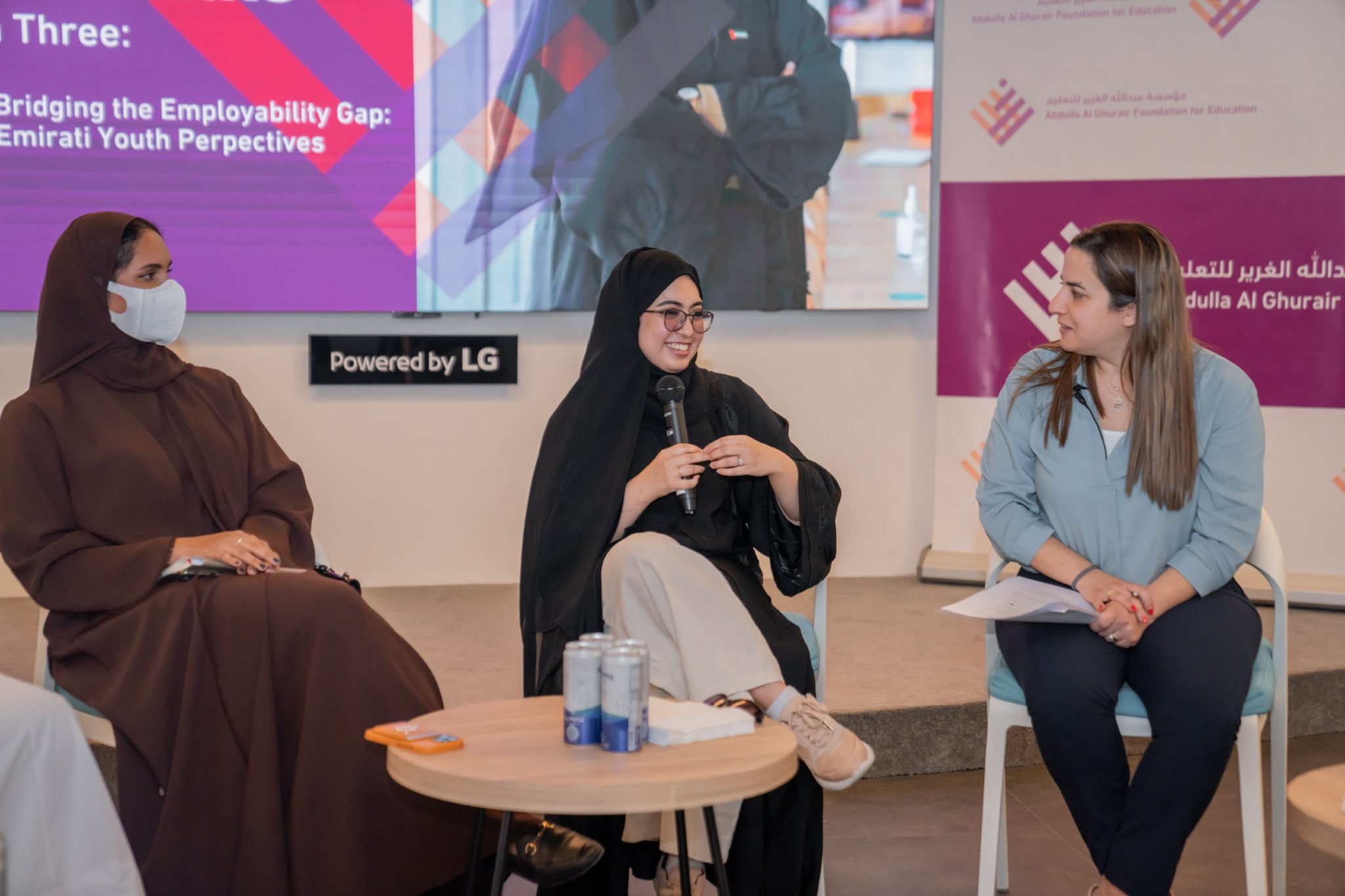 Three women sitting on chairs next to each other representing the AGF's role in building a community of evidence-informed decision-makers.