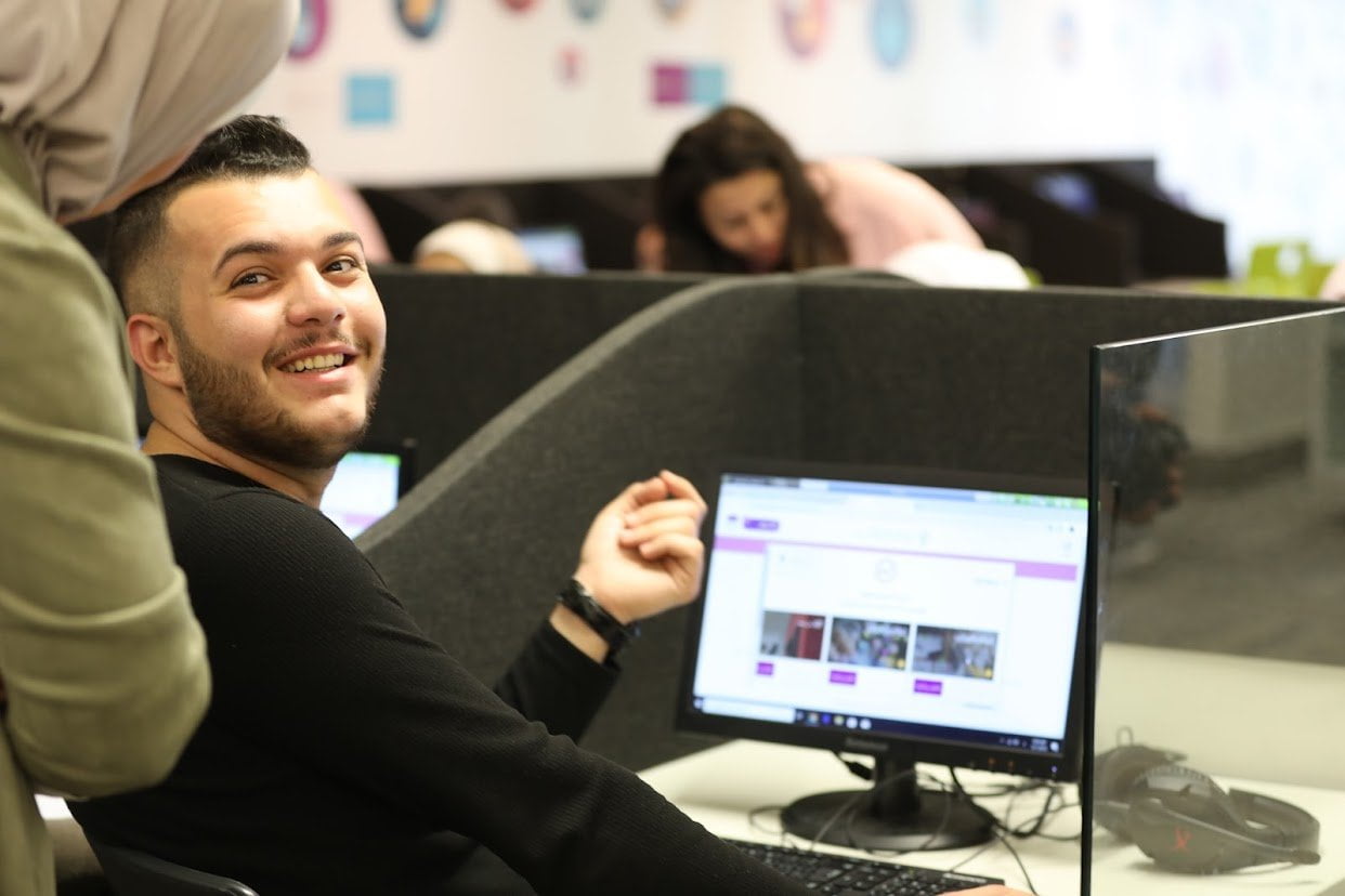 A Student smiles while doing virtual internship program on a computer. AGF'S pilot program  collaborated with Virtual Internships.