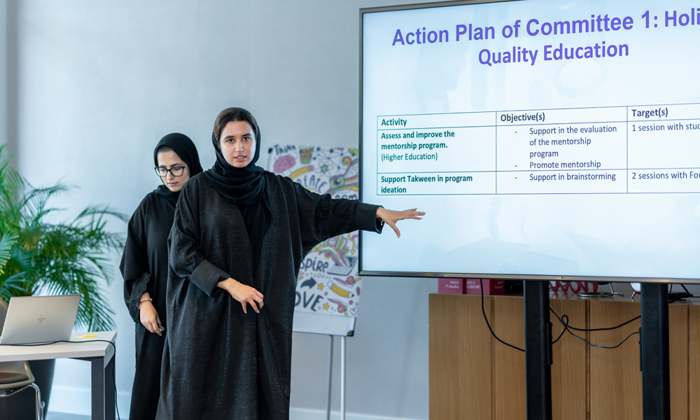A women scholar presenting an action plan for quality education in a meeting room - Al Ghurair Young Thinkers Program.