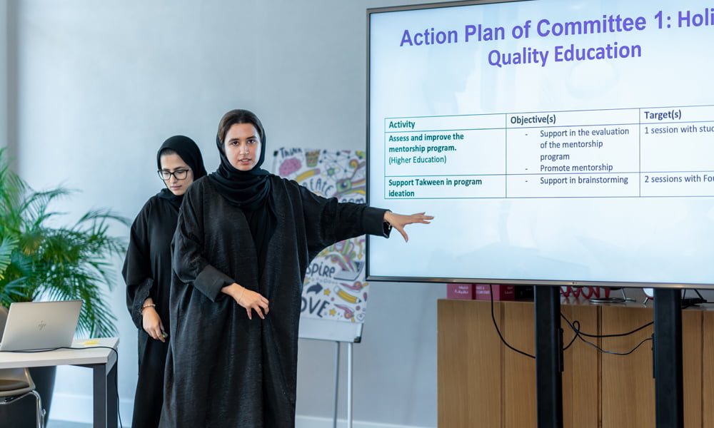 Young-thinkers-program A women scholar presenting an action plan for quality education in a meeting room - Al Ghurair Young Thinkers Program.