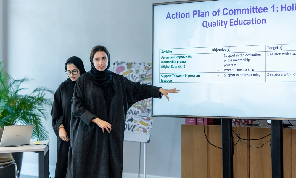Young-thinkers-program A women scholar presenting an action plan for quality education in a meeting room - Al Ghurair Young Thinkers Program.