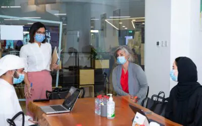 Officials, including the CEO from the AGF, engaged in a meeting in a modern office setting.