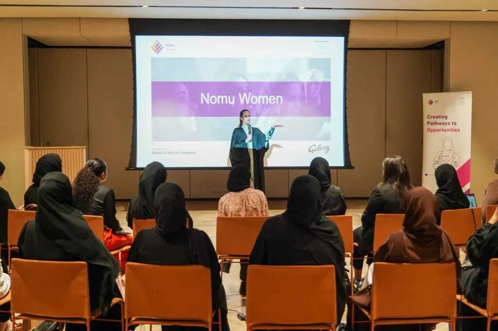 Nomu Women program event hosted by AGF, featuring a speaker presenting to an audience of women