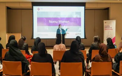 Nomu Women program event hosted by AGF, featuring a speaker presenting to an audience of women