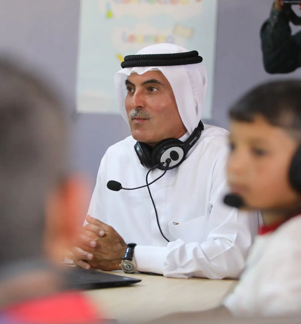 H.E. Abdul Aziz Al Ghurair, Chairman of the AGF appearing engaged in a discussion or educational activity.